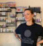 woman wearing EVAM t-shirt in from of herbal display